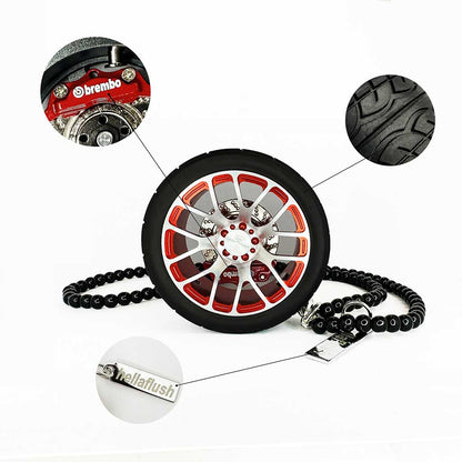A red BBS wheel air-freshener standing on a white floor with bubbles around showcasing its details