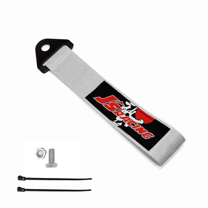 A silver Js racing tow strap, a set of bolt and nut, and two zip ties on a white background