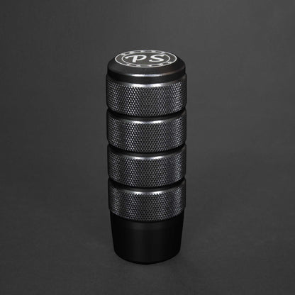 A black shift knob standing on a black background