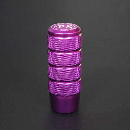A purple shift knob standing on a black background