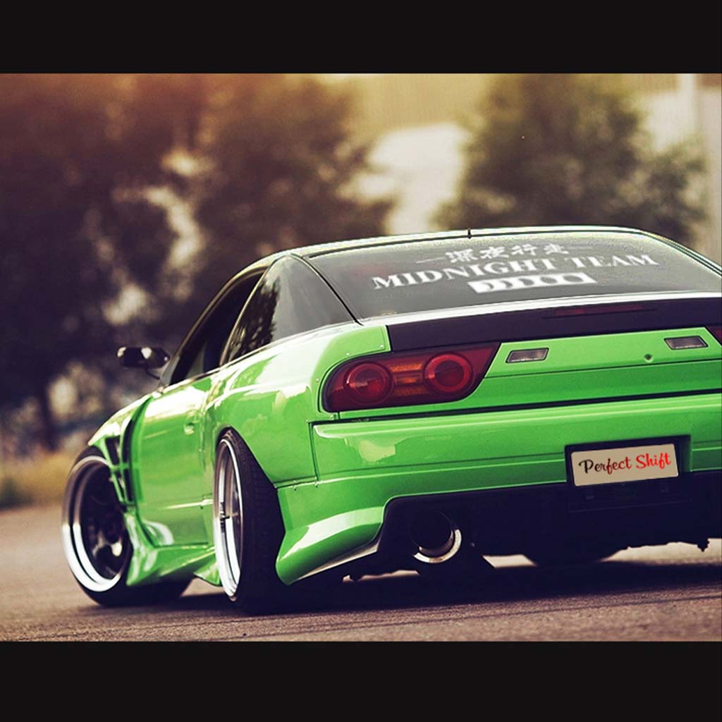 A white Midnight Team car vinyl decal applied on a Silvia's rear window, and the car is parked in an open area