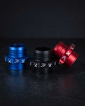 Three anodized shift boot retainers in blue, black, and red, each featuring slotted design and 'Perfect Shift' logo, arranged on a dark surface.