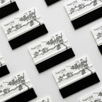 Several JDM banner sticker application squeegees with cherry blossom pattern and Perfect Shift logo orderly placed on a white background