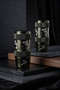 Two black cylindrical stainless steel JDM car shift knobs with textured knurled bands and engraved silver koi fish designs, displayed on a dark tabletop.